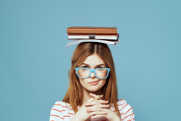 Young girl student with textbooks notebooks and abstracts in hands Premium Photo