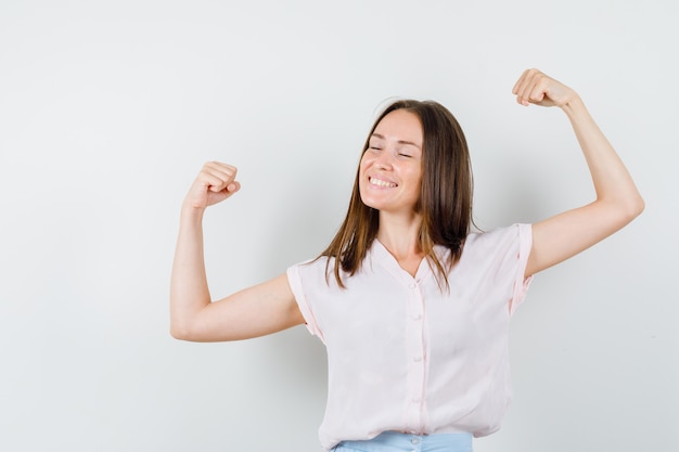 Free Photo | Young girl in t-shirt, skirt showing winner gesture and ...