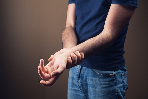 Premium Photo | Young guy has a sore arm