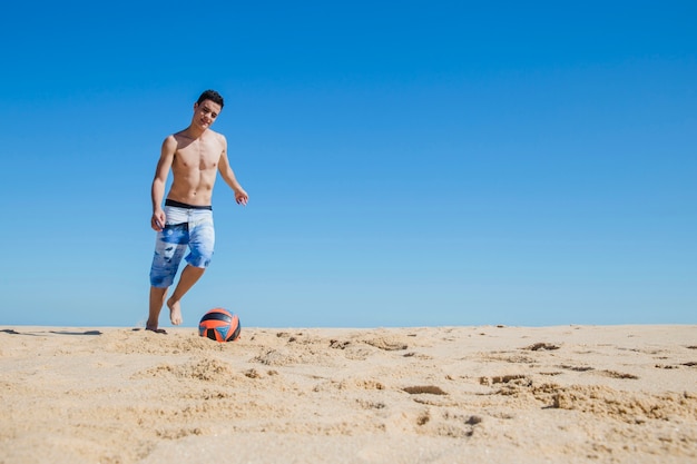 Free Photo | Young guy kicking the ball