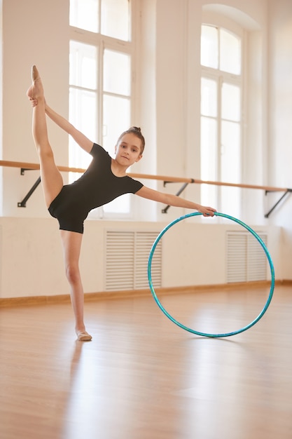 Premium Photo | Young gymnast with hoop