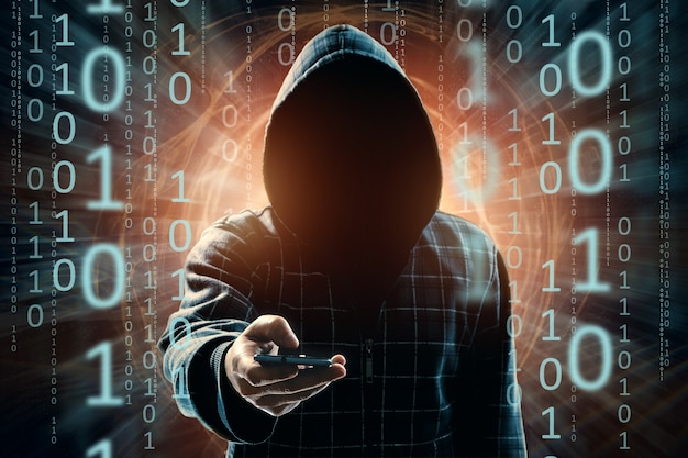 A young hacker in a hood hacks a smartphone, a hacker attack, a silhouette of a man, mixed media Premium Photo