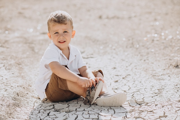 Free Photo | Young handsome boy sitting on the ground