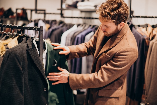 Free Photo | Young handsome man choosing clothes at shop