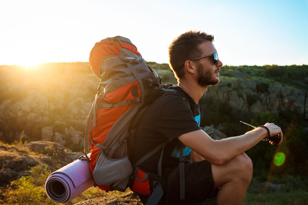 Young handsome man holding walkie talkie radio, enjoying canyon view Free Photo