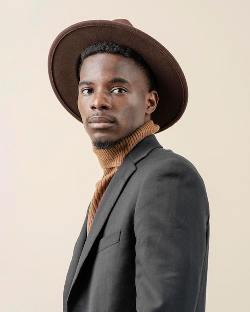 Free Photo | Young handsome man posing with hat
