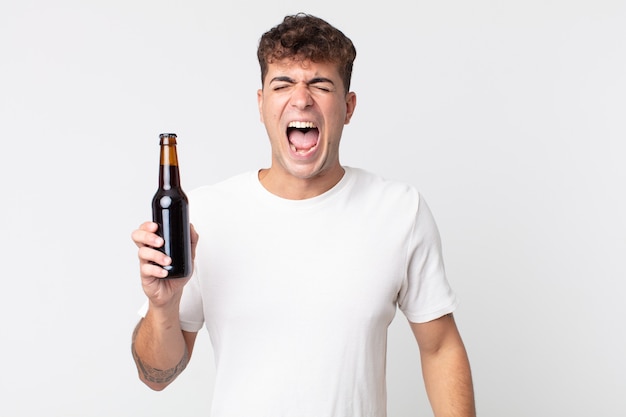 Premium Photo | Young handsome man shouting aggressively, looking very ...