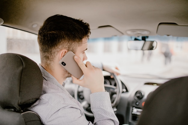 Free Photo Young Handsome Man Talking On Cell Phone While Driving And