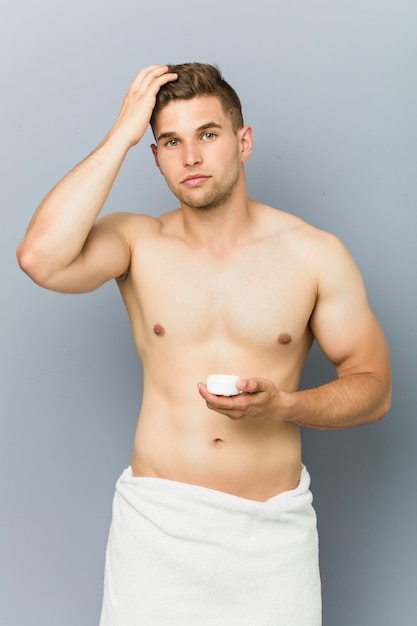 Premium Photo | Young handsome man using hair wax