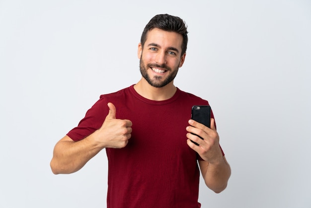 Premium Photo Young handsome man with beard using mobile