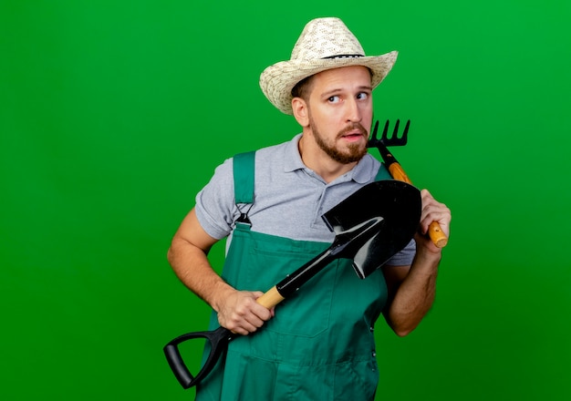 Free Photo | Young handsome slavic gardener in uniform and hat holding ...