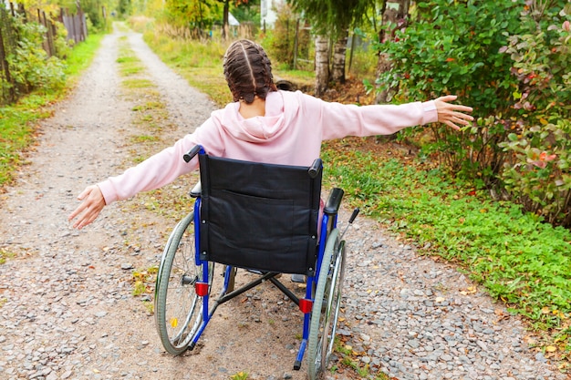 Premium Photo  Young happy handicap woman in wheelchair on road in  hospital park enjoying freedom. paralyzed girl in invalid chair for  disabled people outdoor in nature. rehabilitation concept.