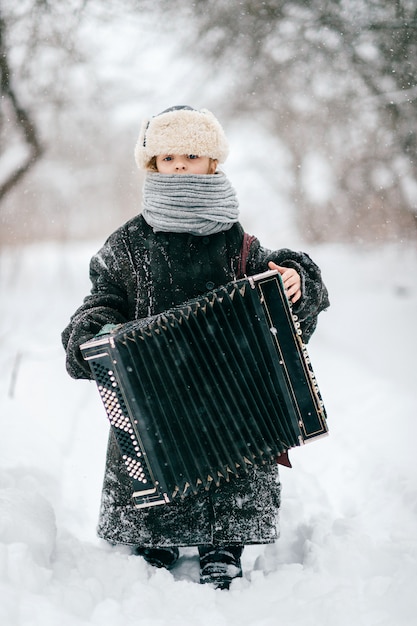 Premium Photo | Young happy musician. comic girl hold accordion. lovely