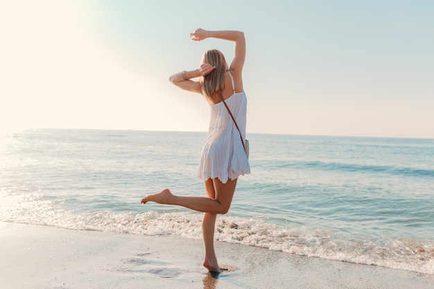 Free Photo | Young happy woman dancing turning around by sea beach ...