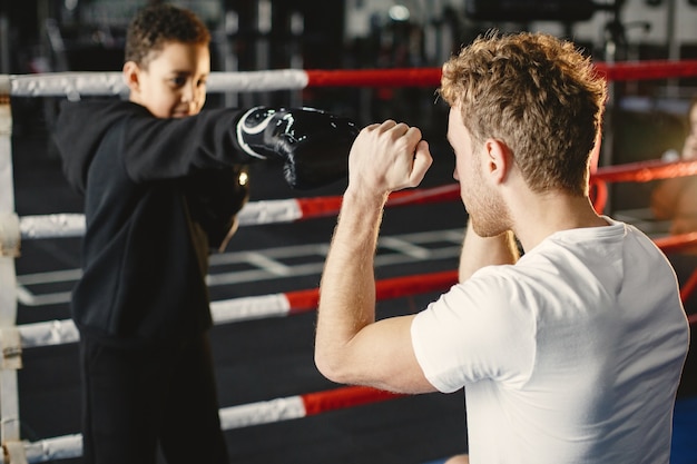 Young hardworking boxer learning to box. child at sport center. kid taking up a new hobby Free Photo