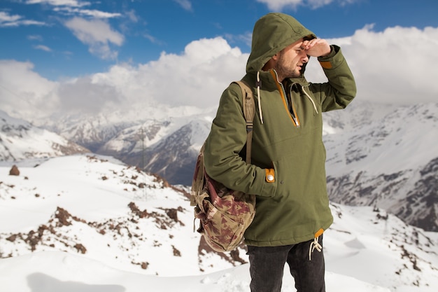 Free Photo | Young hipster man hiking in mountains, winter vacation ...