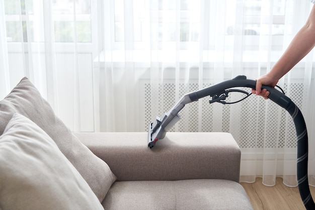Young Housewife Cleaning The Sofa, How To Clean Sofa With Vacuum