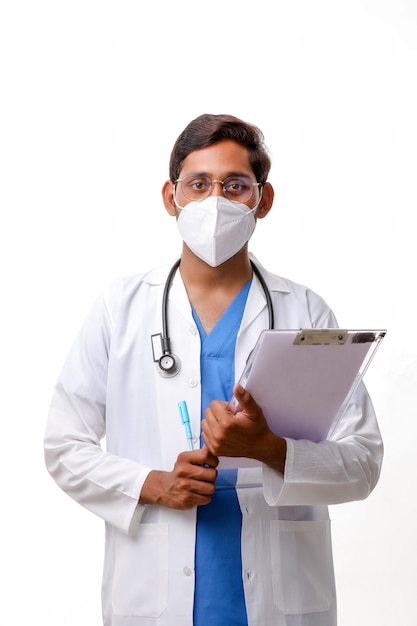 Premium Photo Young Indian Male Doctor Dressed In Uniform With Stethoscope Taking Notes In