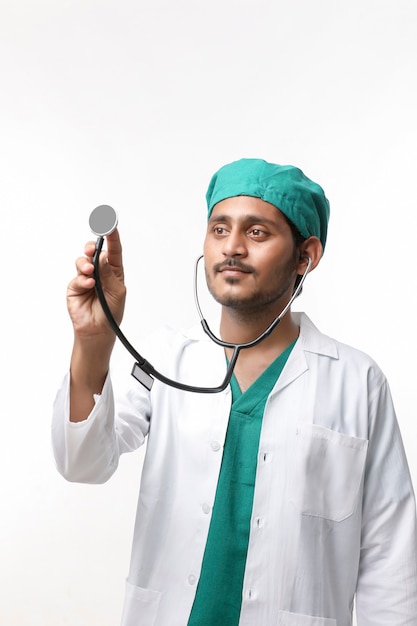 Premium Photo Young Indian Male Doctor Holding Stethoscope In Hand On White Background