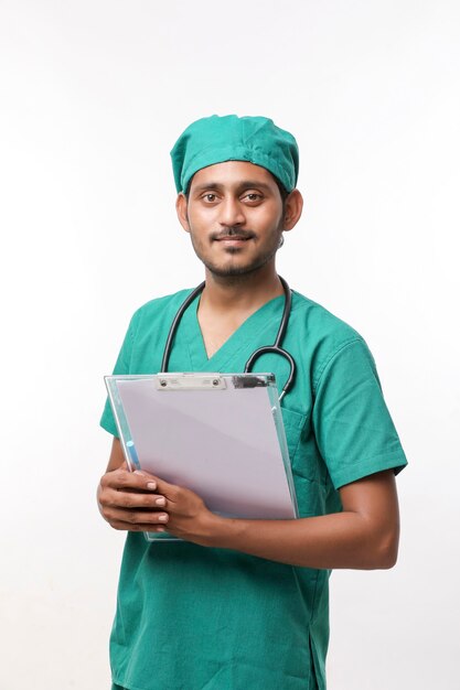 Premium Photo Young Indian Male Doctor In Uniform With Stethoscope Taking Notes In Notepad