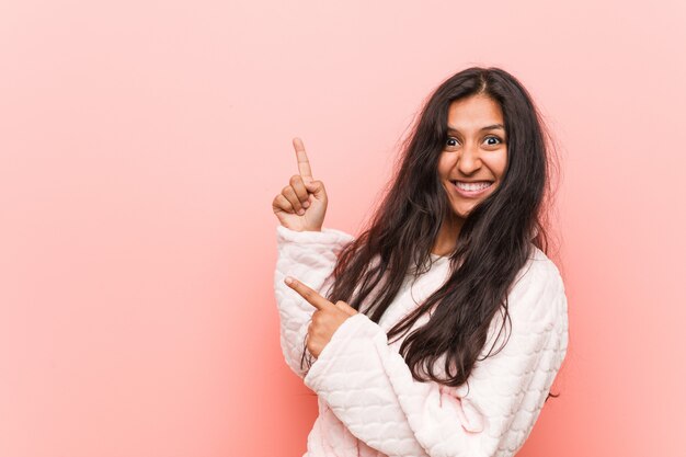 Download Free Young Indian Woman Wearing Pajama Pointing With Forefingers To A Use our free logo maker to create a logo and build your brand. Put your logo on business cards, promotional products, or your website for brand visibility.