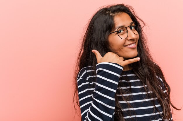 Young Intellectual Indian Woman Showing A Mobile Phone Call Gesture