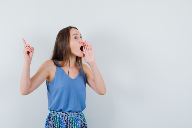 Free Photo | Young lady calling someone with loud voice in blouse,skirt ...