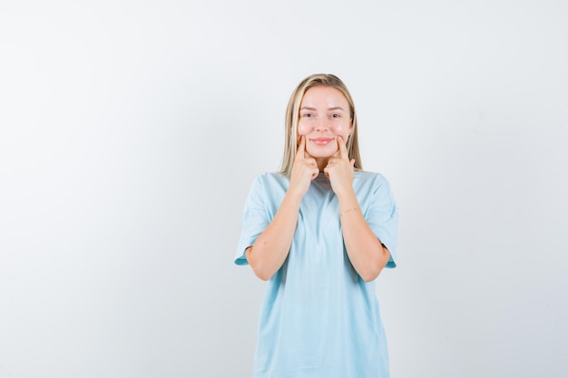 Free Photo | Young lady pressing fingers on cheeks in t-shirt and ...