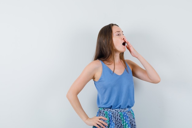 Free Photo | Young lady yawning with hand on mouth in blue blouse,skirt ...