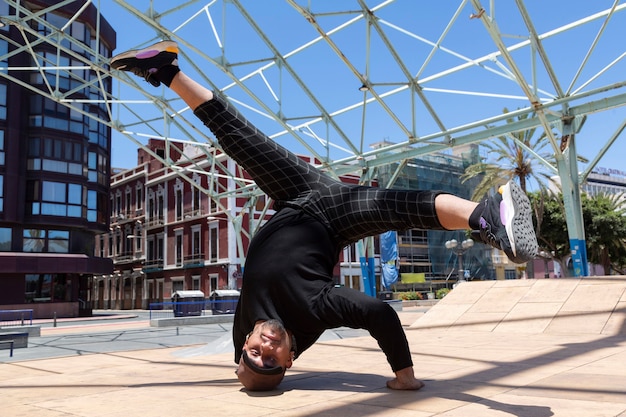 Premium Photo | Young latin man urban acrobatic dancer on the street ...