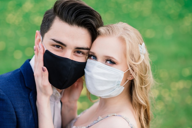 Young Loving Couple Wearing Face Masks On Their Wedding Day Premium Photo