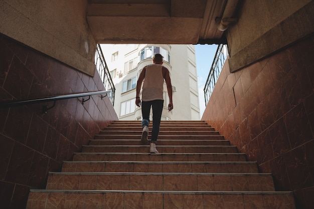 若い男が歩行者の地下鉄で階段を登る 無料の写真
