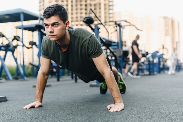 Premium Photo | A young man does push-ups on the street on a ...