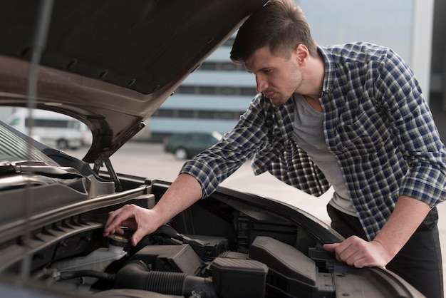 Free Photo | Young man fixing car