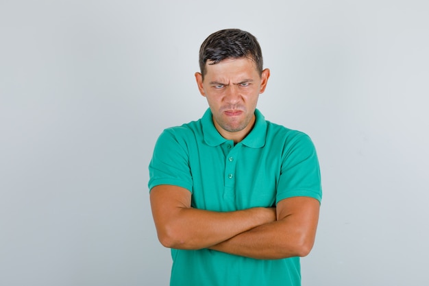 Free Photo | Young man in green t-shirt standing with crossed arms and ...