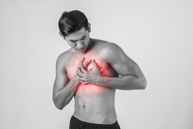 Young man has heart attack isolated on white background. Free Photo