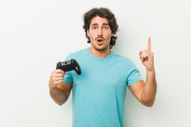 Premium Photo Young Man Holding A Game Controller Having Some Great