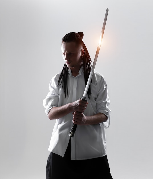 Premium Photo Young Man Holding A Samurai Sword Glamour Photo