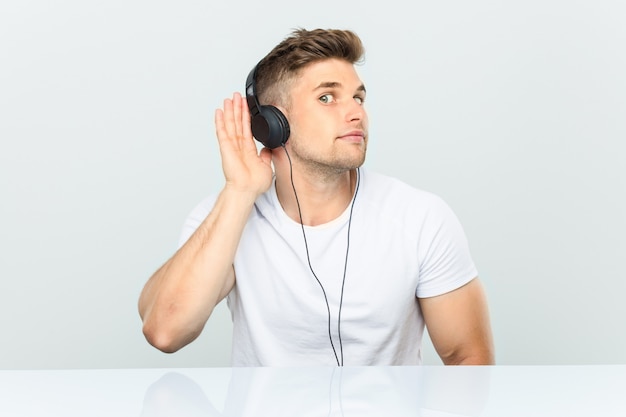 Premium Photo | Young man listening to music with headphones trying to ...