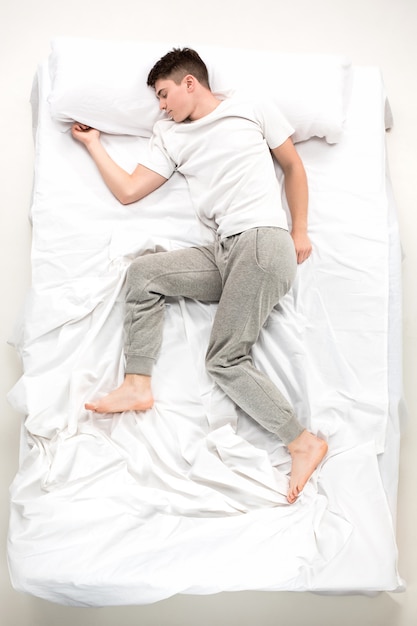 The Young Man Lying In A Bed Free Photo