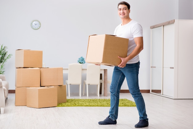 Premium Photo | Young man moving boxes at home