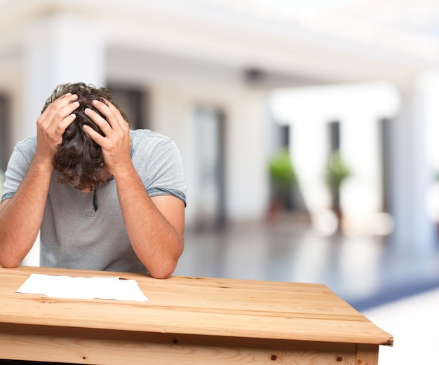 young man on a table. worried expression Free Photo