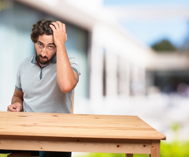 young man on a table. worried expression Free Photo