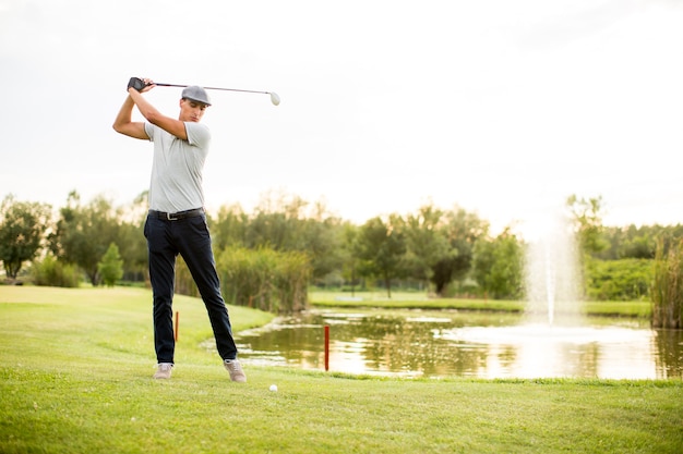 Premium Photo | Young man playing golf