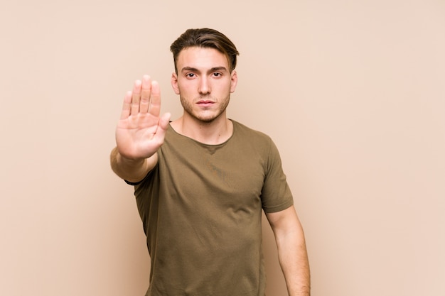 Premium Photo Young Man Posing Standing With Outstretched Hand Showing Stop Sign Preventing You