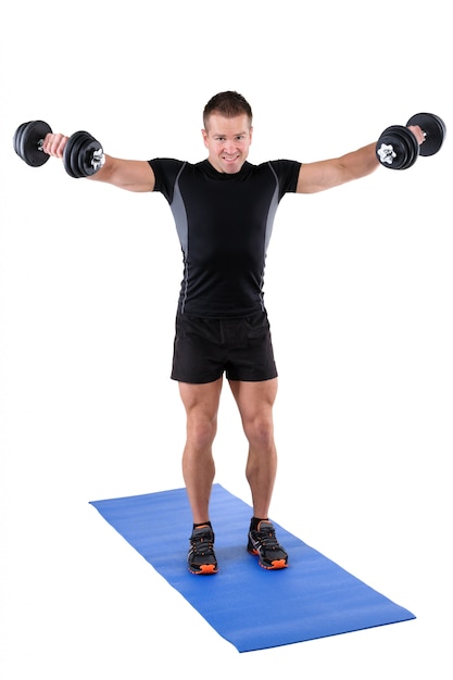 Premium Photo | Young man shows finishing position of dumbbell lateral ...