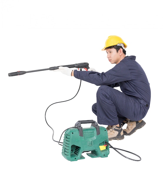 Young man sitting and holding high pressure water gun Premium Photo