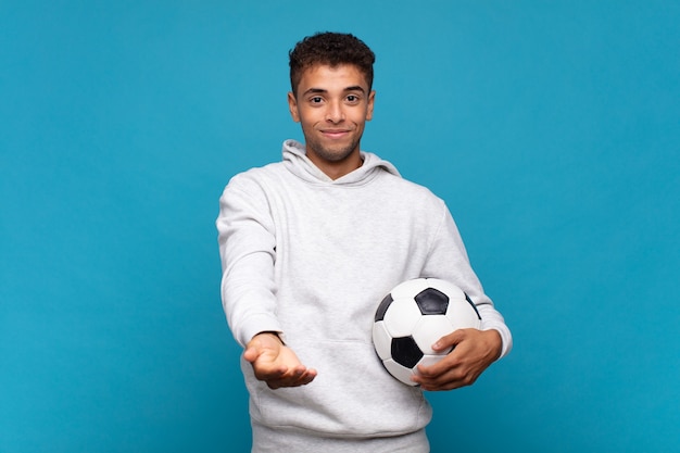 Premium Photo | Young man smiling happily with friendly look