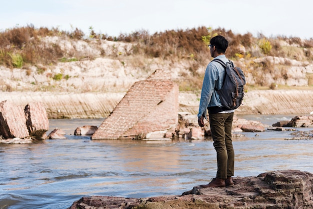 Free Photo | Young man standing near water