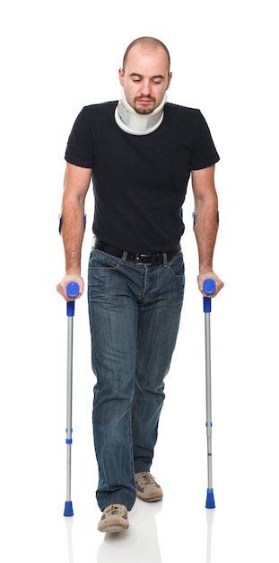 Premium Photo | Young man standing with crutches